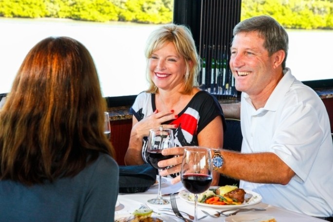 a group of people sitting at a table with wine glasses