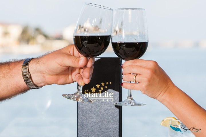 a hand holding a glass of wine