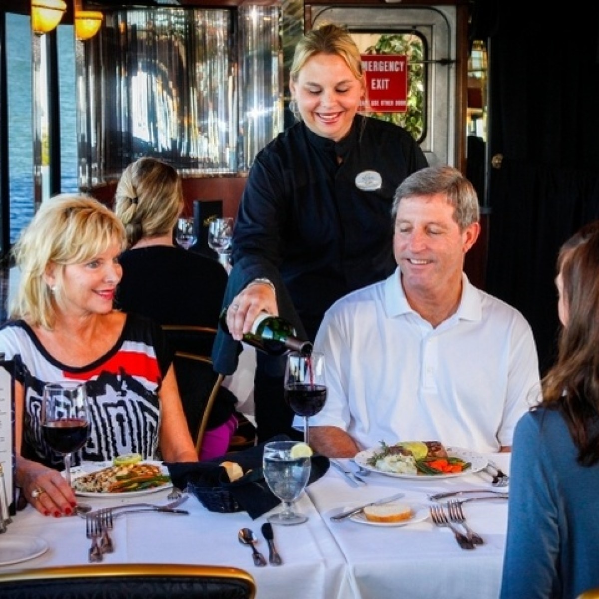 a group of people sitting at a table in a restaurant