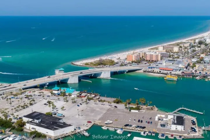 a crowded beach next to the ocean