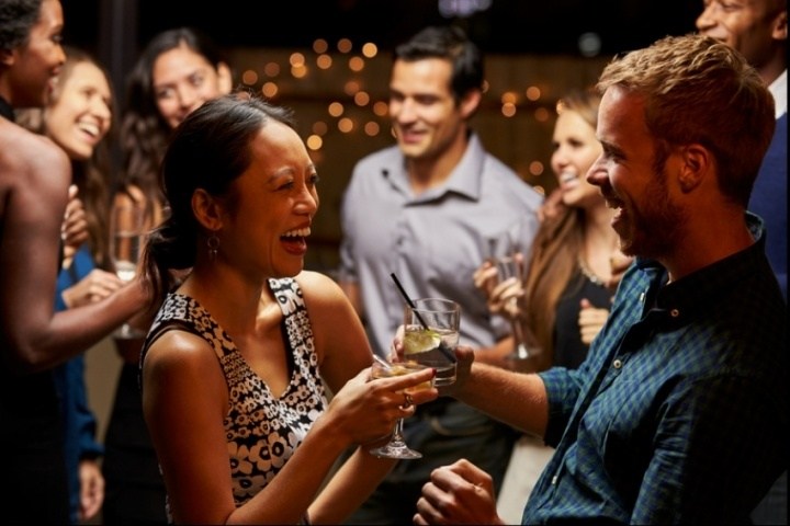 a group of people holding wine glasses