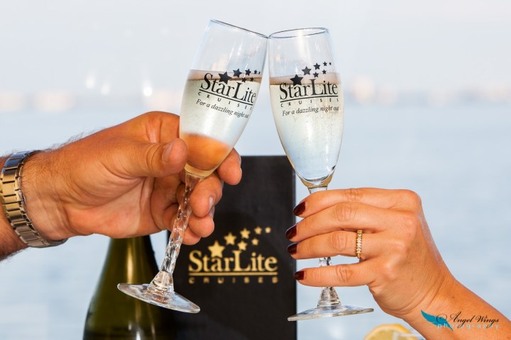 a hand holding a glass of wine