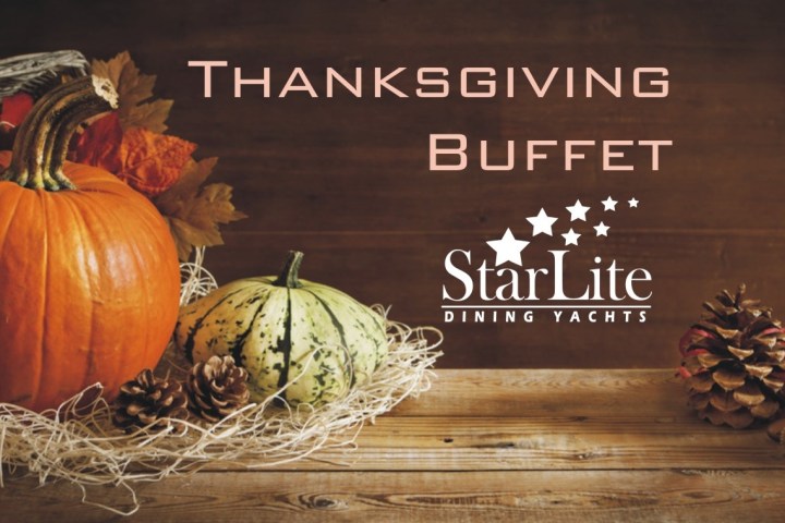 Thanksgiving Buffet sign with pumpkins, pine cones, and autumn leaves on a wooden surface.